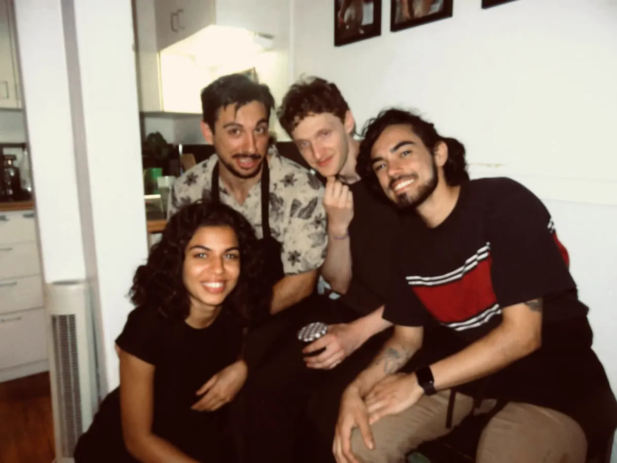 Four team members in aprons, posing together in the kitchen