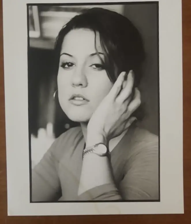 Framed black and white print: portrait of a young woman, hand in her hair