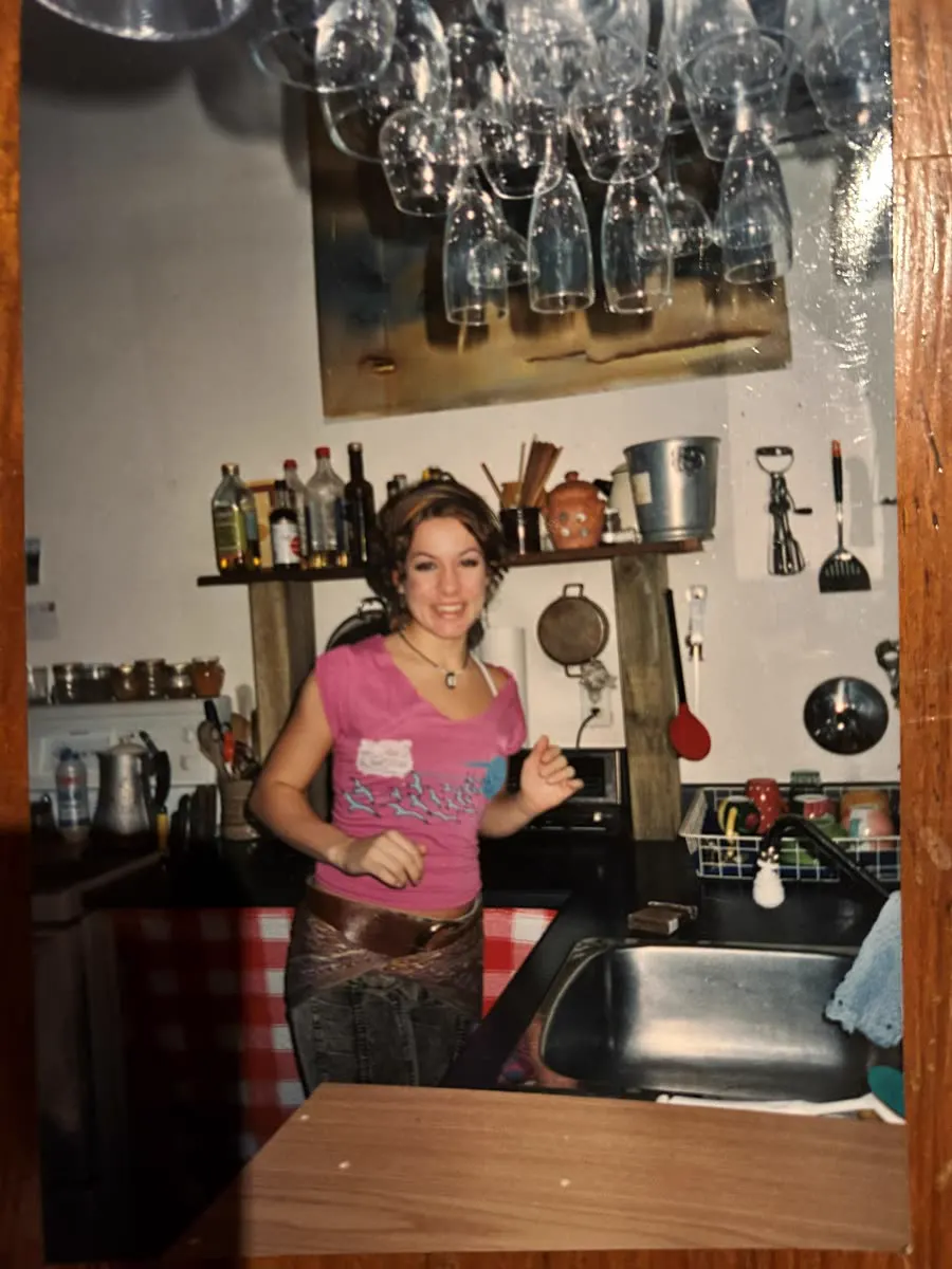 Vintage photo of a young woman behind a kitchen counter