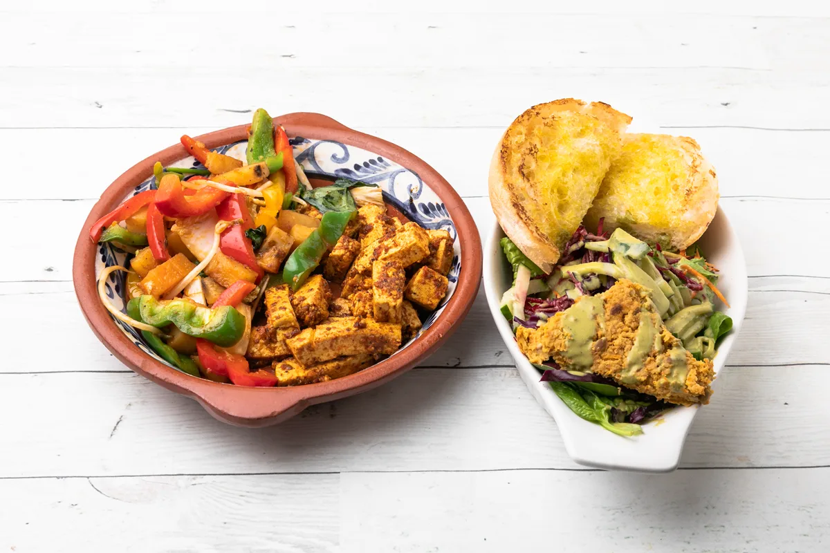 Vegan breakfast: marinated tofu, sautéed vegetables, salad and toast