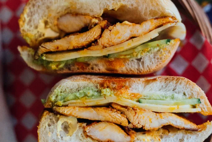 Churrasco sandwich: marinated chicken, cheese, guacamole and cucumber